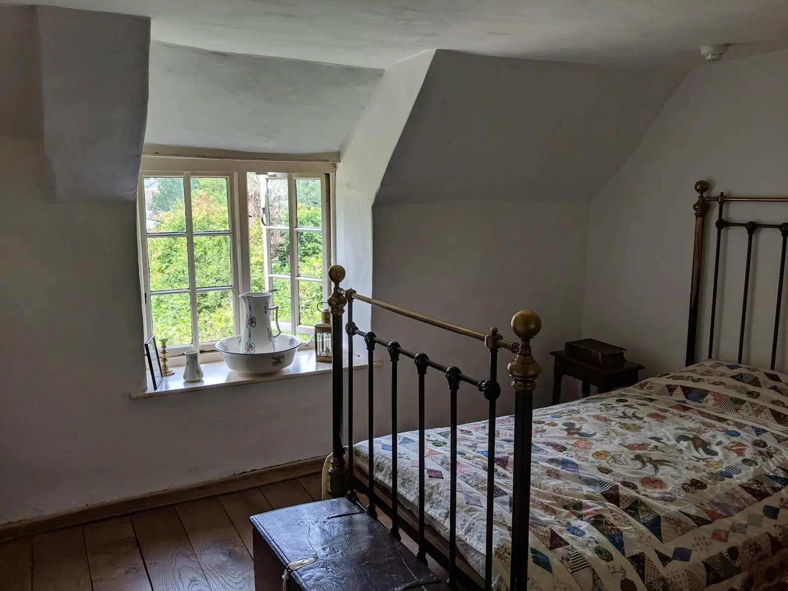 A finished bedroom with smooth walls and a sash window
