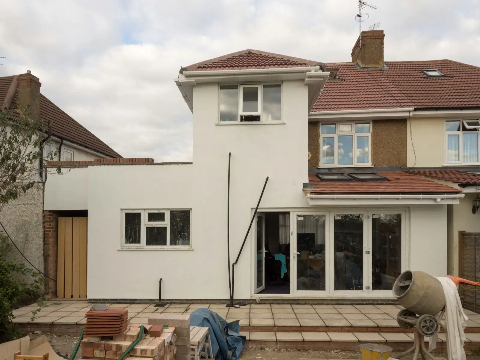 A semi-detached house with a newly rendered white extension