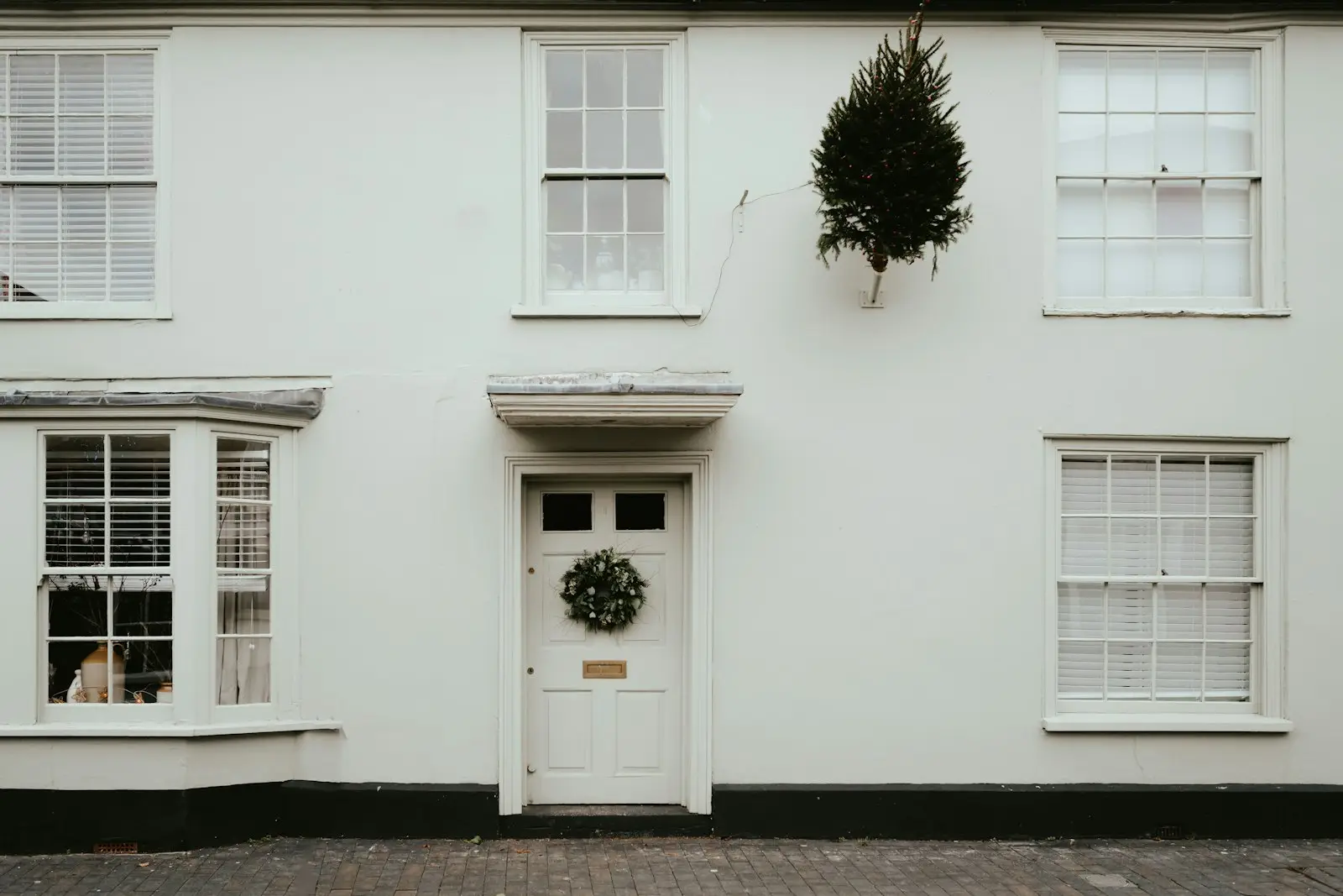 A white house with a wreath on the front door