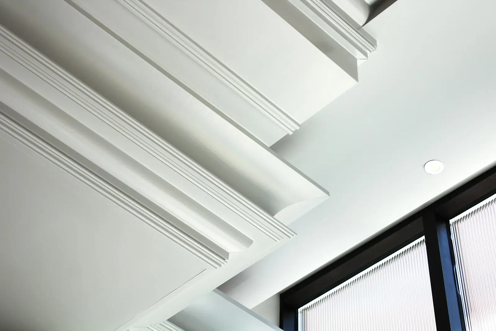 A smooth white ceiling meeting a crisp cornice