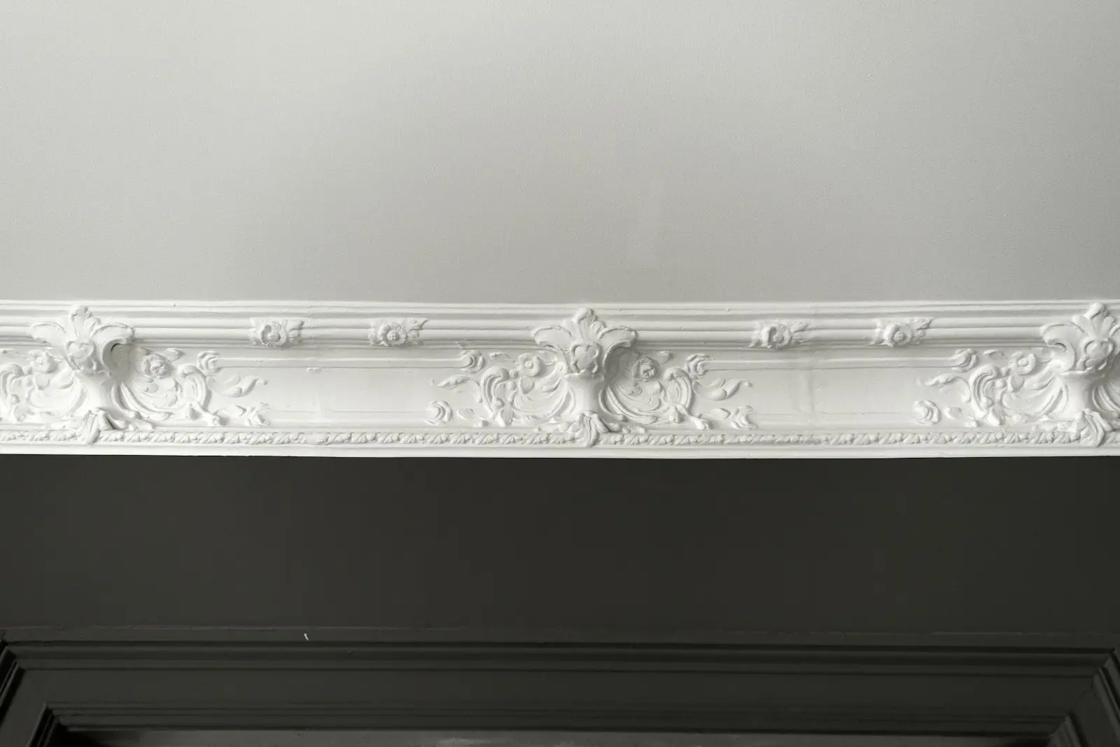Ornate white plaster cornice where the wall meets the ceiling