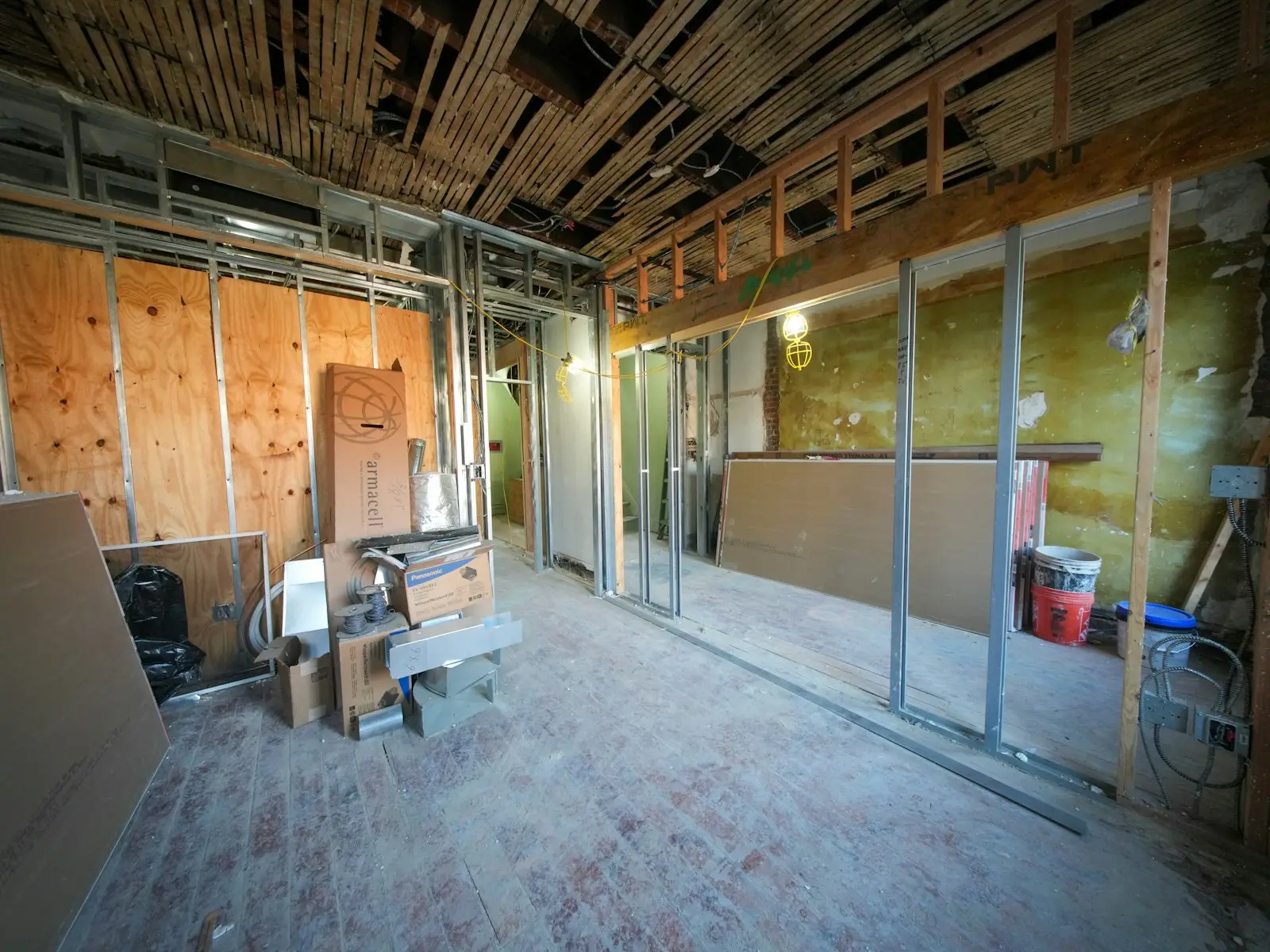 A room under construction with new stud walls and plasterboard