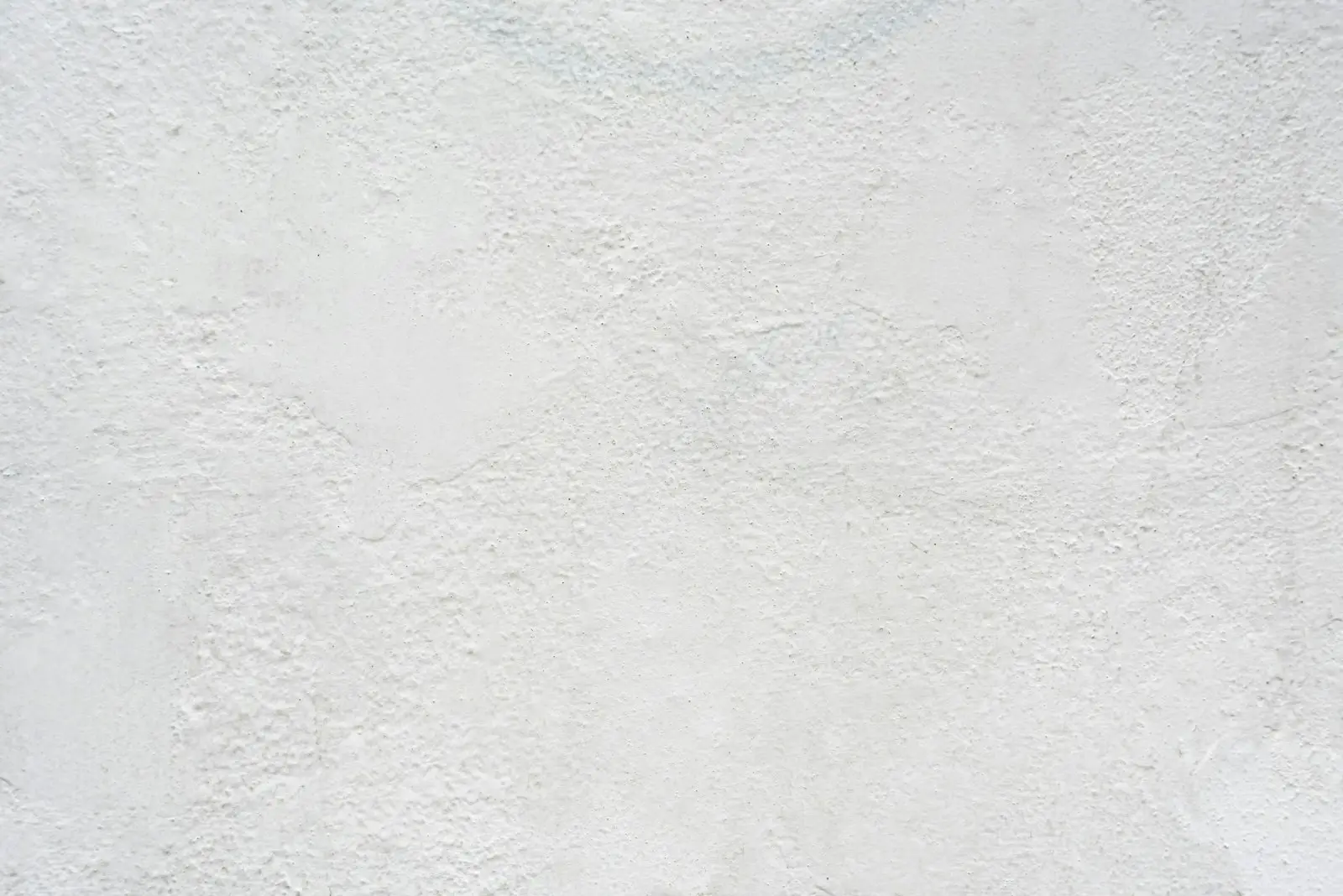 A smooth, freshly finished white plaster wall
